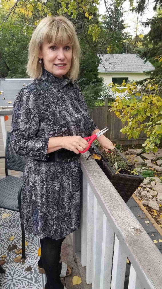 Corina gathering herbs from the garden