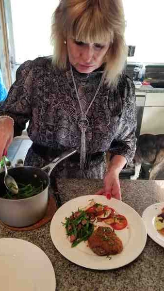 Corina plating dinner at the counter